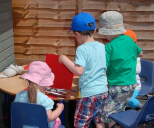 King's Castle Montessori Nursery children drawing outside